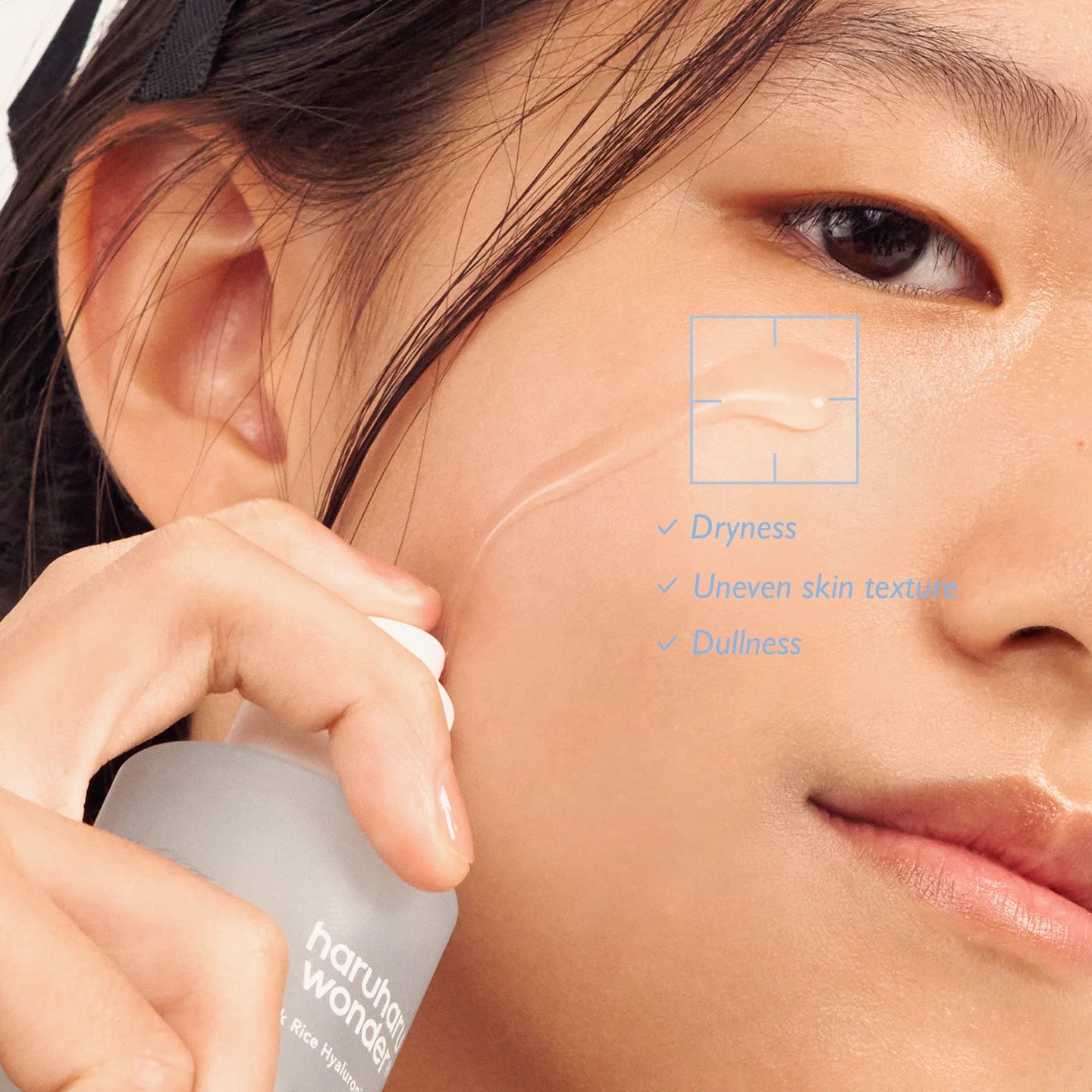 Close-up of Haruharu Wonder Black Rice Hyaluronic Essence being applied to skin, leaving it soft and smooth