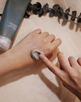 Isntree Real Mugwort Clay Mask being gently massaged onto skin, soothing and exfoliating while cleaning pores