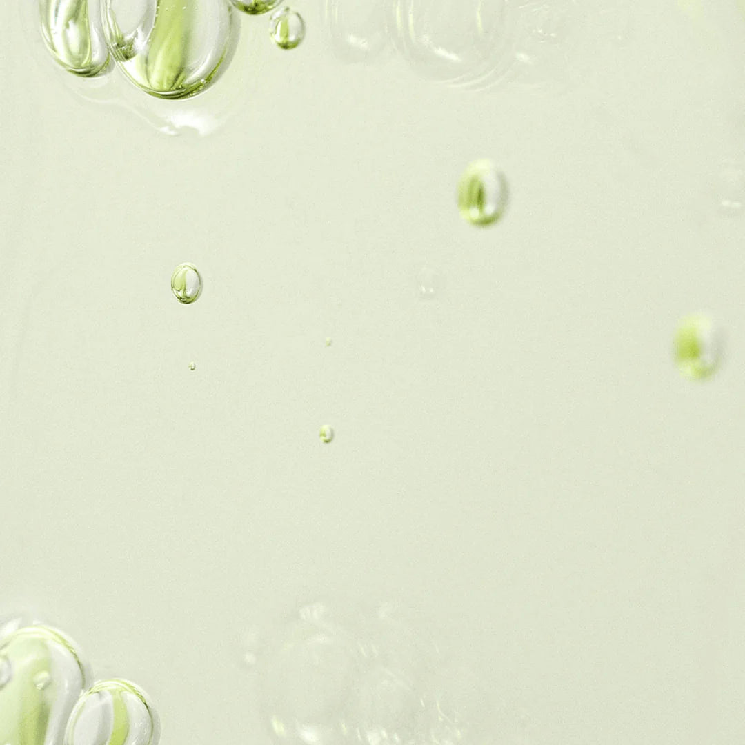 Model gently applying Beauty of Joseon Calming Serum Green Tea + Panthenol to the face, showcasing its ability to soothe, hydrate, and calm irritated skin