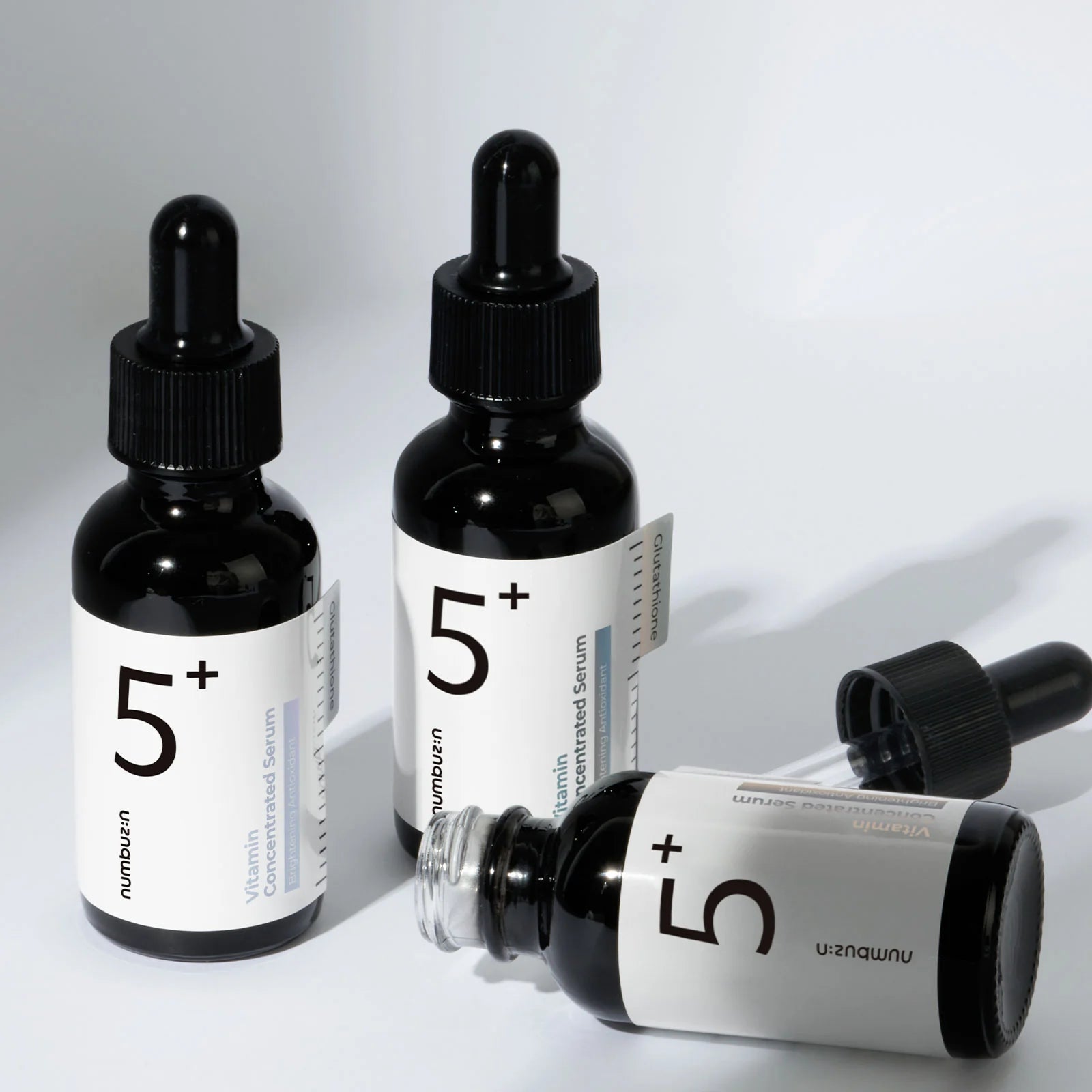 Numbuzin No.5 Vitamin Concentrated Serum (50 ml) bottle showcasing the formula with glutathione, vitamin C, and tranexamic acid to target pigmentation, dark spots, and uneven skin tone, providing a radiant, brightened complexion.