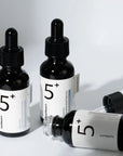Numbuzin No.5 Vitamin Concentrated Serum (50 ml) bottle showcasing the formula with glutathione, vitamin C, and tranexamic acid to target pigmentation, dark spots, and uneven skin tone, providing a radiant, brightened complexion.