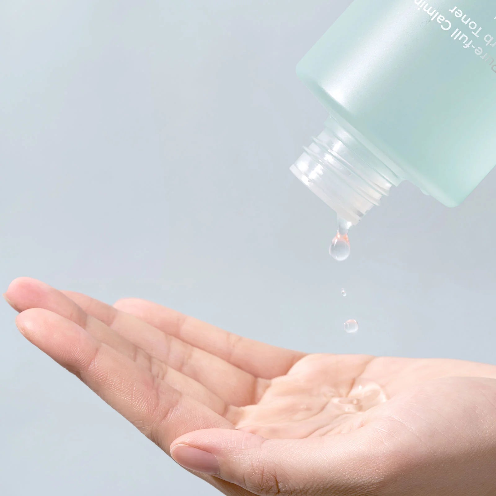 numbuzin toners Close-up of toner being applied to a cotton pad, showcasing its light, watery texture and cooling, refreshing feel, perfect for sensitive or acne-prone skin.