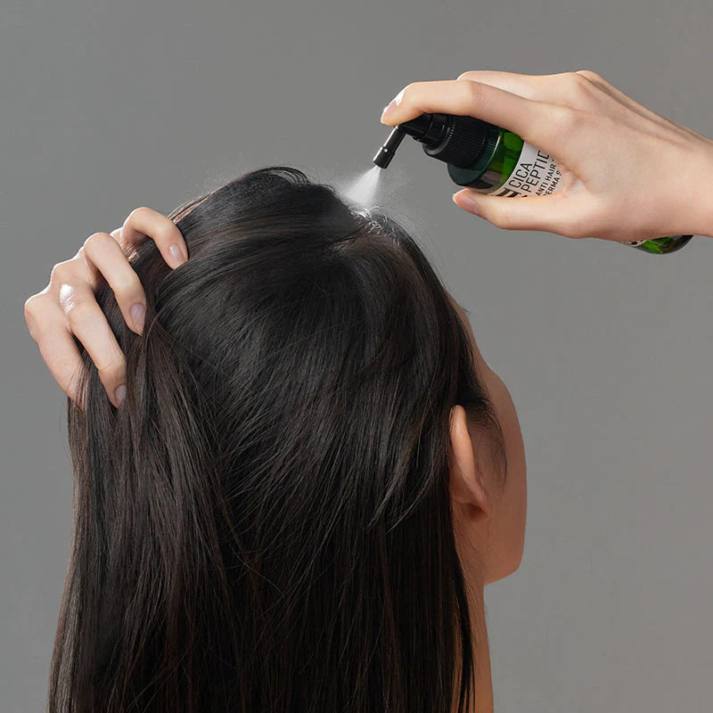 Some By Mi Cica Peptide Anti Hair Loss Derma Scalp Tonic – Gently massaging the tonic into the scalp to enhance absorption and promote healthier hair growth.