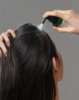 Some By Mi Cica Peptide Anti Hair Loss Derma Scalp Tonic – Gently massaging the tonic into the scalp to enhance absorption and promote healthier hair growth.