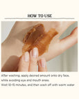 Applying Skinfood Black Sugar Mask Wash Off – Gently massaging the mask in circular motions on damp skin for exfoliation and hydration.