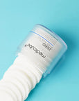 Close-up of the embossed and smooth sides of the pore pad – Showing how the textured side exfoliates while the smooth side helps the essence absorb into the skin, leaving it hydrated and smooth.
