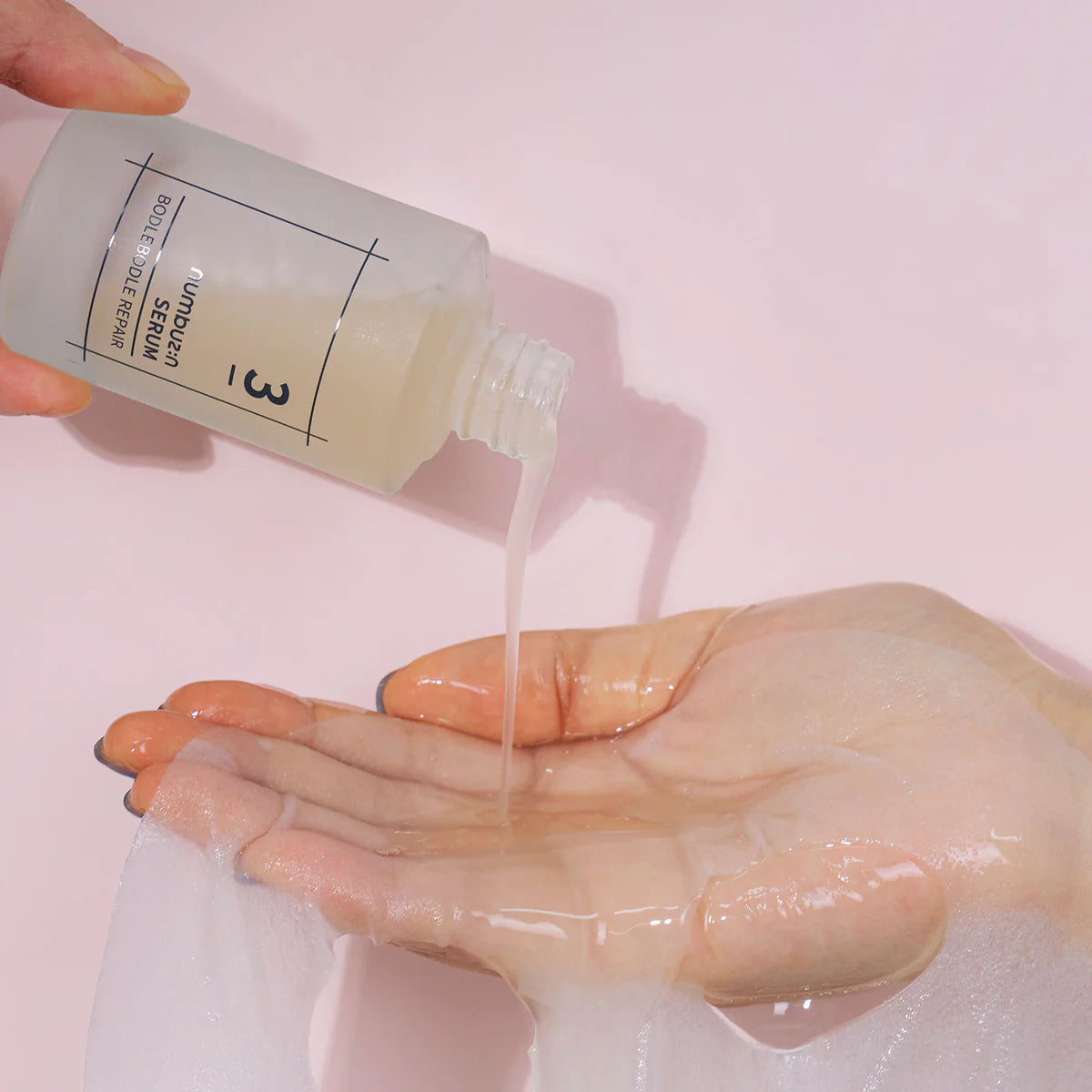 Close-up of the serum being dispensed, showing its lightweight, fast-absorbing texture without any sticky residue, emphasizing deep hydration and smooth skin.