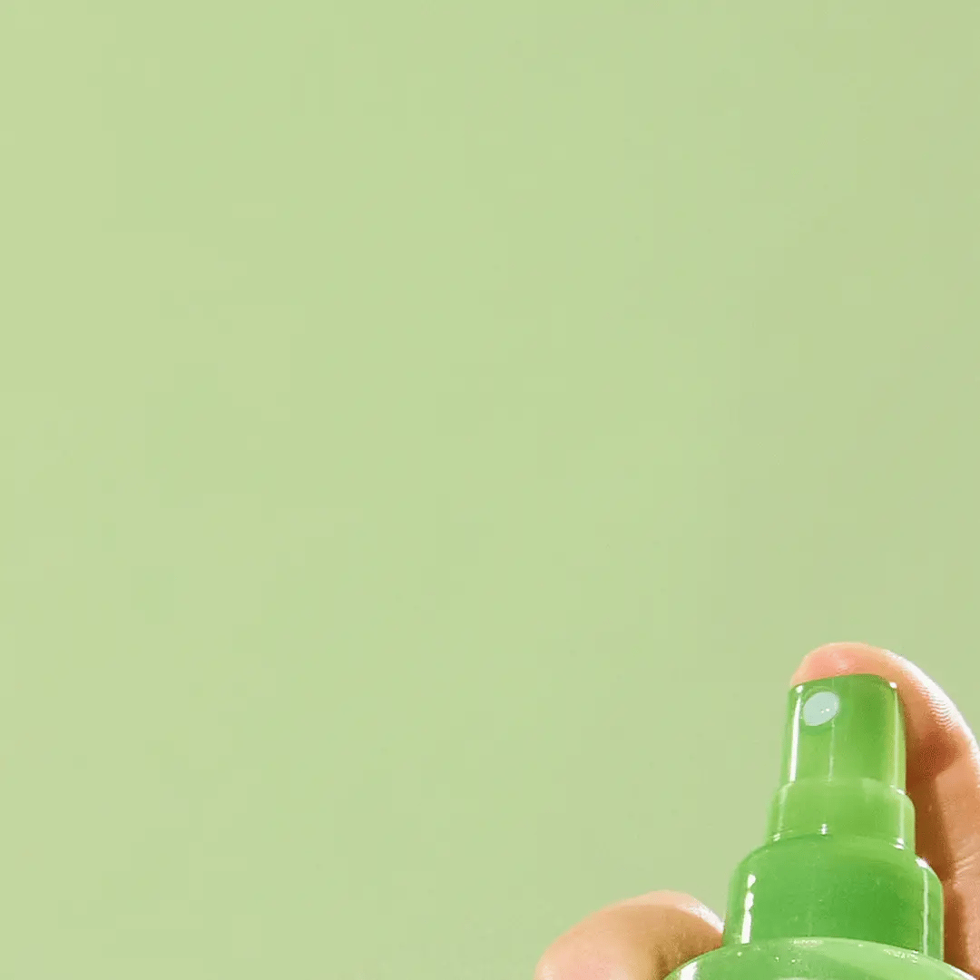 Person spraying Nature Republic Aloe Vera Soothing Gel Mist on the face, showing a refreshing burst of mist being applied gently to the skin.