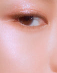 Close-up of skin showing the radiant, glowing effect of Peripera Ink V Highlighter 01 Radiance Shot, with visible luminous sheen on the cheekbones and nose, providing a natural, soft glow.