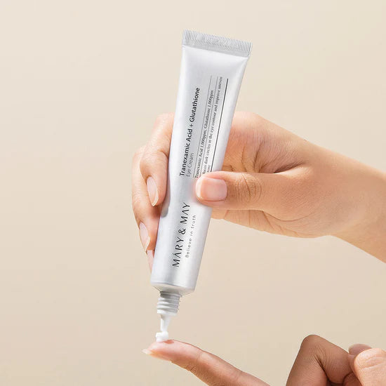 Applying Mary & May Tranexamic Acid + Glutathione Eye Cream to the under-eye area – Gently patting the cream around the eyes to brighten dark circles and smooth fine lines and wrinkles.