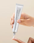 Applying Mary & May Tranexamic Acid + Glutathione Eye Cream to the under-eye area – Gently patting the cream around the eyes to brighten dark circles and smooth fine lines and wrinkles.