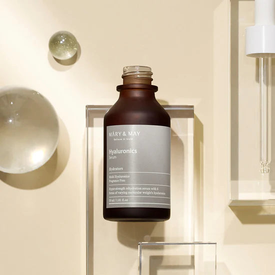 Close-up of Mary & May Multi Hyaluronic Serum packaging – Highlighting the sleek bottle design and emphasizing the six types of hyaluronic acid that lock in hydration and promote smooth, hydrated skin.