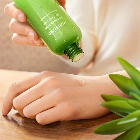 Applying Innisfree Green Tea Balancing Skin EX – light, non-greasy toner with minerals and amino acids for smooth, hydrated, and refreshed skin