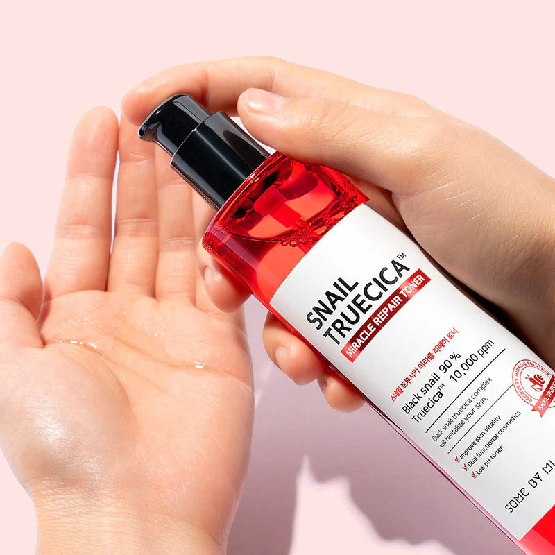 Some By Mi Snail Truecica Miracle Repair Toner – Close-up of the toner being applied with a cotton pad, showing its smooth and hydrating formula for repairing damaged skin.