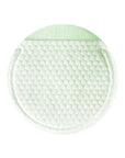 Close-up image of a cotton gauze pad with green tea extract, demonstrating its exfoliating and soothing texture.