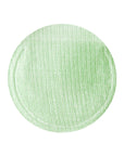 Close-up image of a cotton gauze pad with green tea extract, demonstrating its exfoliating and soothing texture.