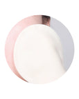 Image of a person using a cotton gauze pad to gently exfoliate their face, showing the two sides of the pad – the gauze peeling side and embossed side – in action.