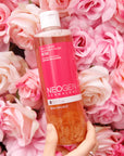 Neogen Real Flower Cleansing Water (Rose) (300 ml) featuring real rose petals floating in the bottle, emphasizing its hydrating and soothing properties for dry, sensitive skin.