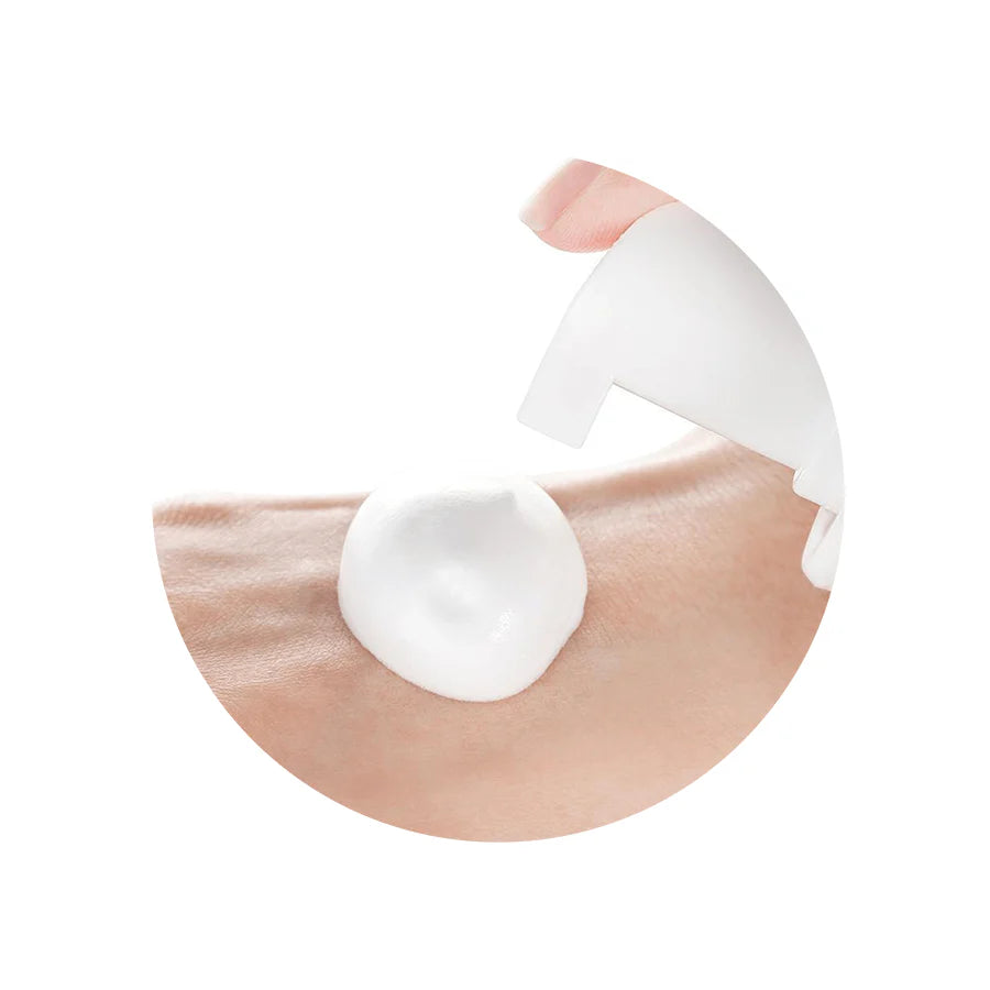 Person massaging the foam onto their face, showing how the product gently foams up, soothing and hydrating the skin while removing impurities.