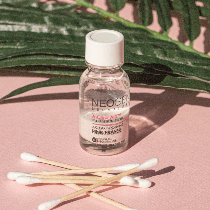 Neogen A Clear Soothing Pink Eraser bottle with visible pink sediment at the bottom, highlighting the soothing and acne-fighting properties of the treatment.