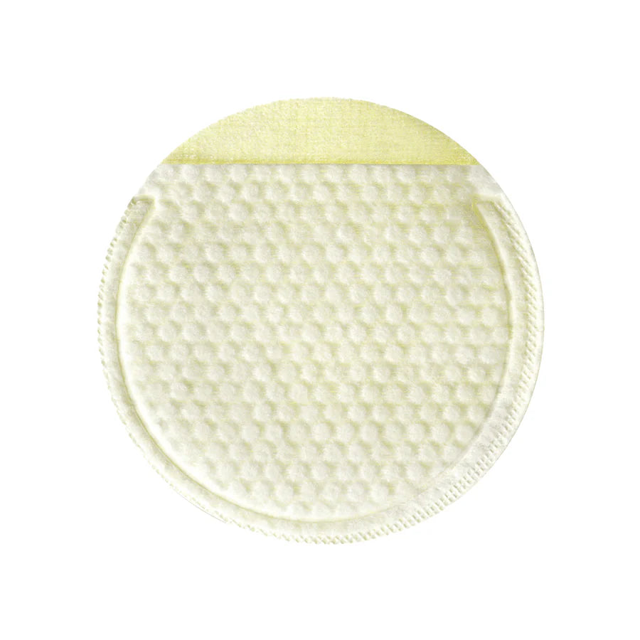 Close-up of a cotton gauze pad soaked in lemon serum, demonstrating its exfoliating texture while effectively removing dead skin cells and impurities.