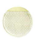 Close-up of a cotton gauze pad soaked in lemon serum, demonstrating its exfoliating texture while effectively removing dead skin cells and impurities.