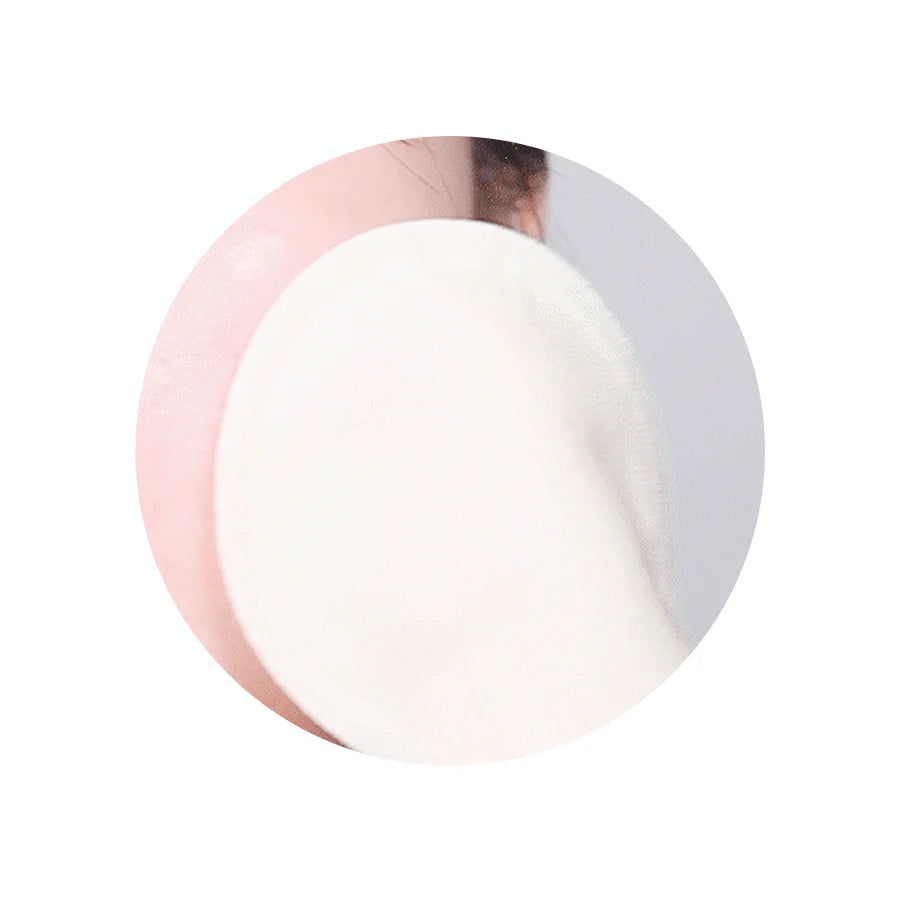 Image of a person using a cotton gauze pad to gently exfoliate their face, showing the two sides of the pad in action—gauze peeling side for exfoliation, embossed side for cleansing.