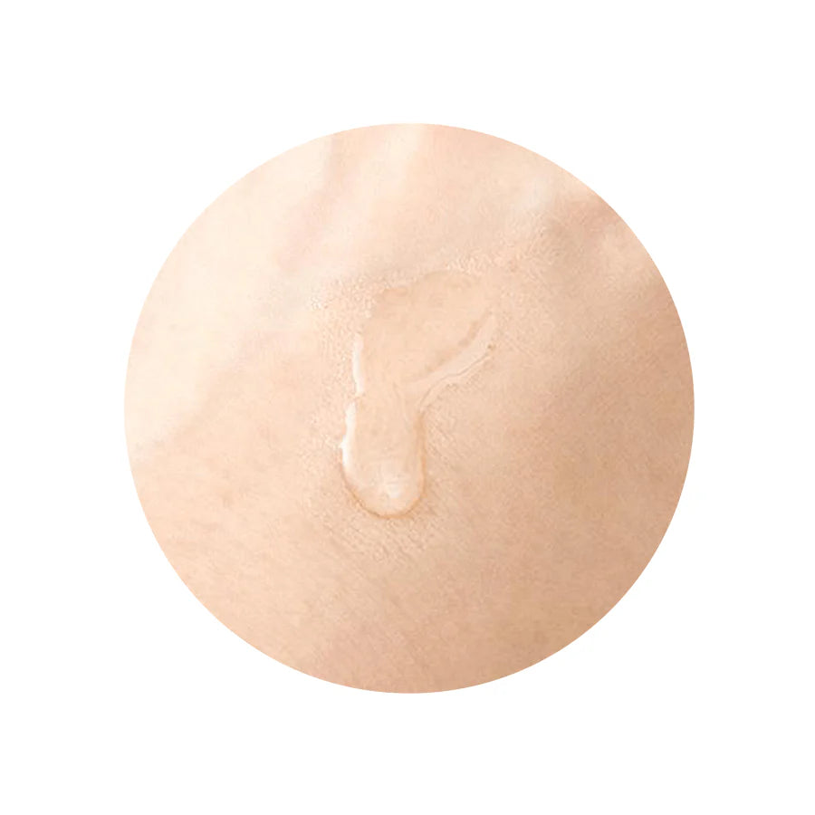 Person gently patting the essence into their skin with hands or a cotton pad, demonstrating how easily the essence absorbs and preps the skin for the next steps in the skincare routine.