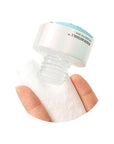 Close-up of the essence being dispensed, showing its lightweight, watery texture that absorbs quickly into the skin, emphasizing its fast-absorbing, non-sticky consistency.
