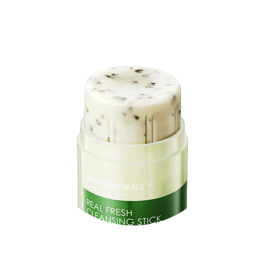 Close-up shot of Neogen Real Fresh Cleansing Stick being applied to wet skin, showing its smooth, creamy texture and gentle exfoliating action from crushed green tea leaves.
