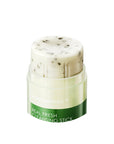 Close-up shot of Neogen Real Fresh Cleansing Stick being applied to wet skin, showing its smooth, creamy texture and gentle exfoliating action from crushed green tea leaves.