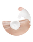 Person gently massaging the foamy cleanser onto the face, showing its smooth, creamy texture and mild, soothing application for sensitive skin.