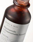 Close-up of Mary & May Niacinamide Chaenomeles Sinensis Serum packaging – Featuring the sleek bottle and highlighting its brightening and sebum-balancing properties.