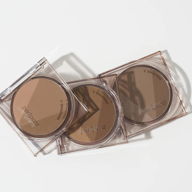 Peripera Ink V Shading contour powder in a compact size, designed for creating natural 3D shading on the face. Comes in three shades: Almond Brown 01, Cacao Brown 02, and Hazel Gray, providing a sculpted, soft, and smooth contour finish.