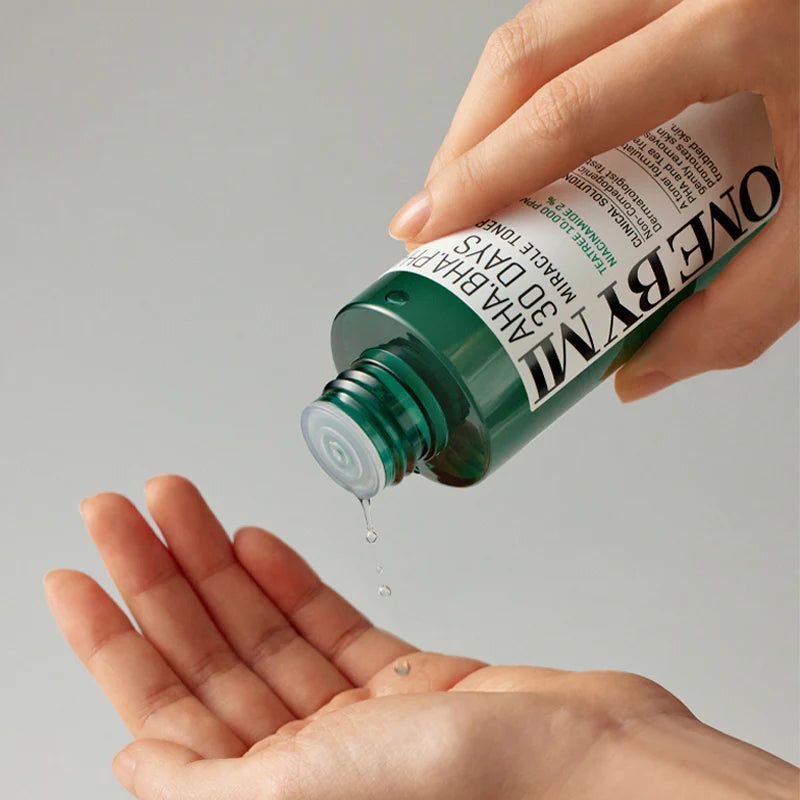 Some By Mi AHA BHA PHA 30 Days Miracle Toner – Clear toner applied on cotton pad for gentle exfoliation and acne control.