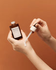 Applying Skin1004 Probio-Cica Intensive Ampoule – Gently patting a few drops of the ampoule onto the face for deep hydration and soothing.