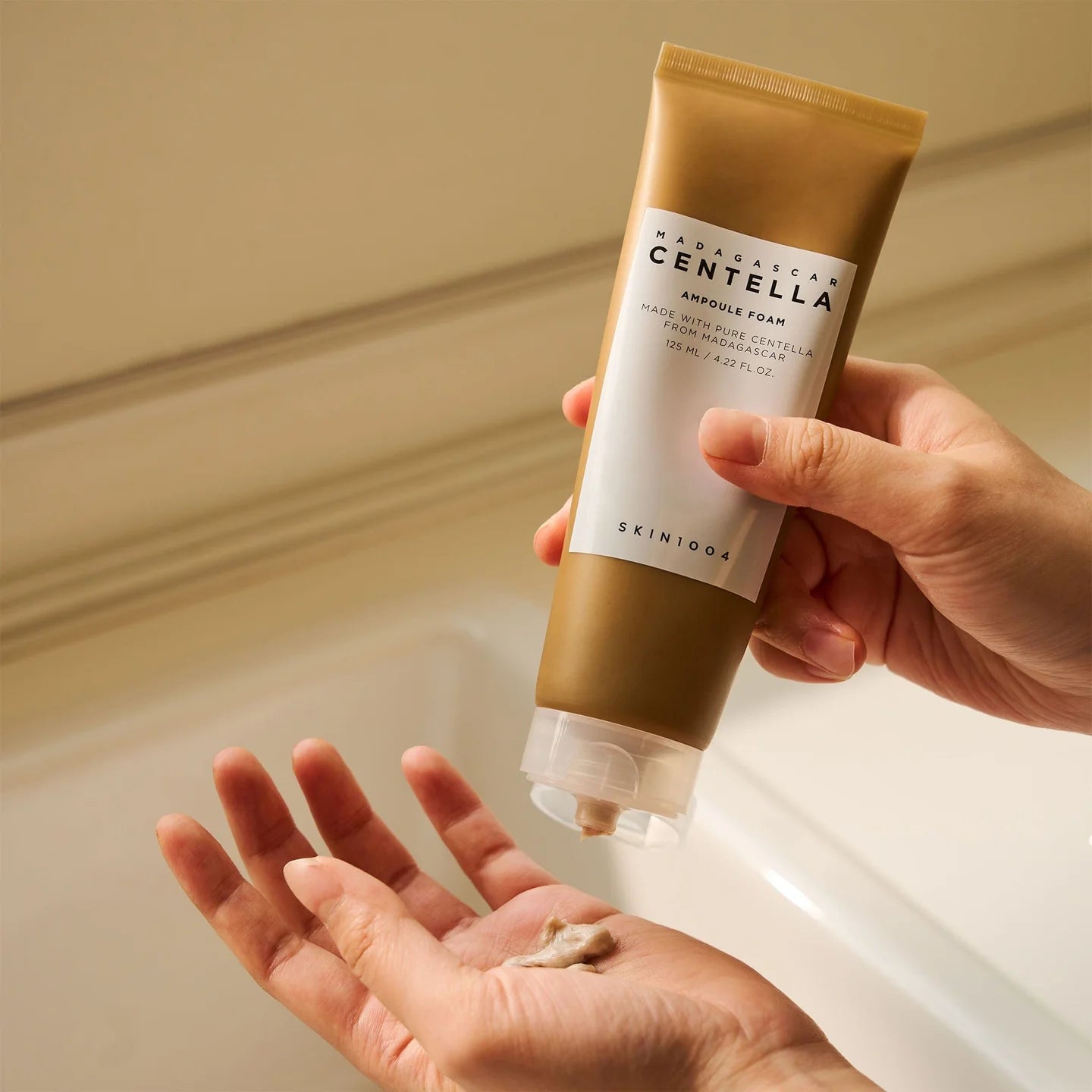 Creating foam with Skin1004 Madagascar Centella Ampoule Foam – Gently massaging creamy foam onto skin for smooth, hydrated finish.