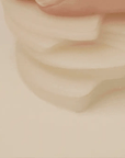 Close-up of Skin1004 Madagascar Centella Quick Calming Pad – Triple-layered crescent-shaped pad soaked with calming essence.