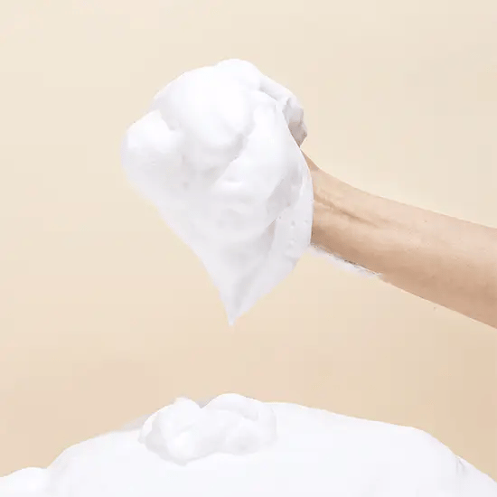 Demonstrating the application of Mary & May White Collagen Cleansing Foam – Foam being massaged onto the face to remove makeup, dirt, and impurities while leaving skin soft and hydrated.