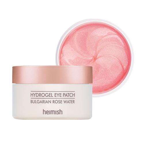 Heimish Bulgarian Rose Hydrogel Eye Patch applied to the under-eye area, brightening and hydrating tired, stressed skin