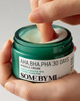 Applying Some By Mi AHA BHA PHA 30 Days Miracle Cream – Gently massaging the cream into the face for a calming and soothing skincare finish.
